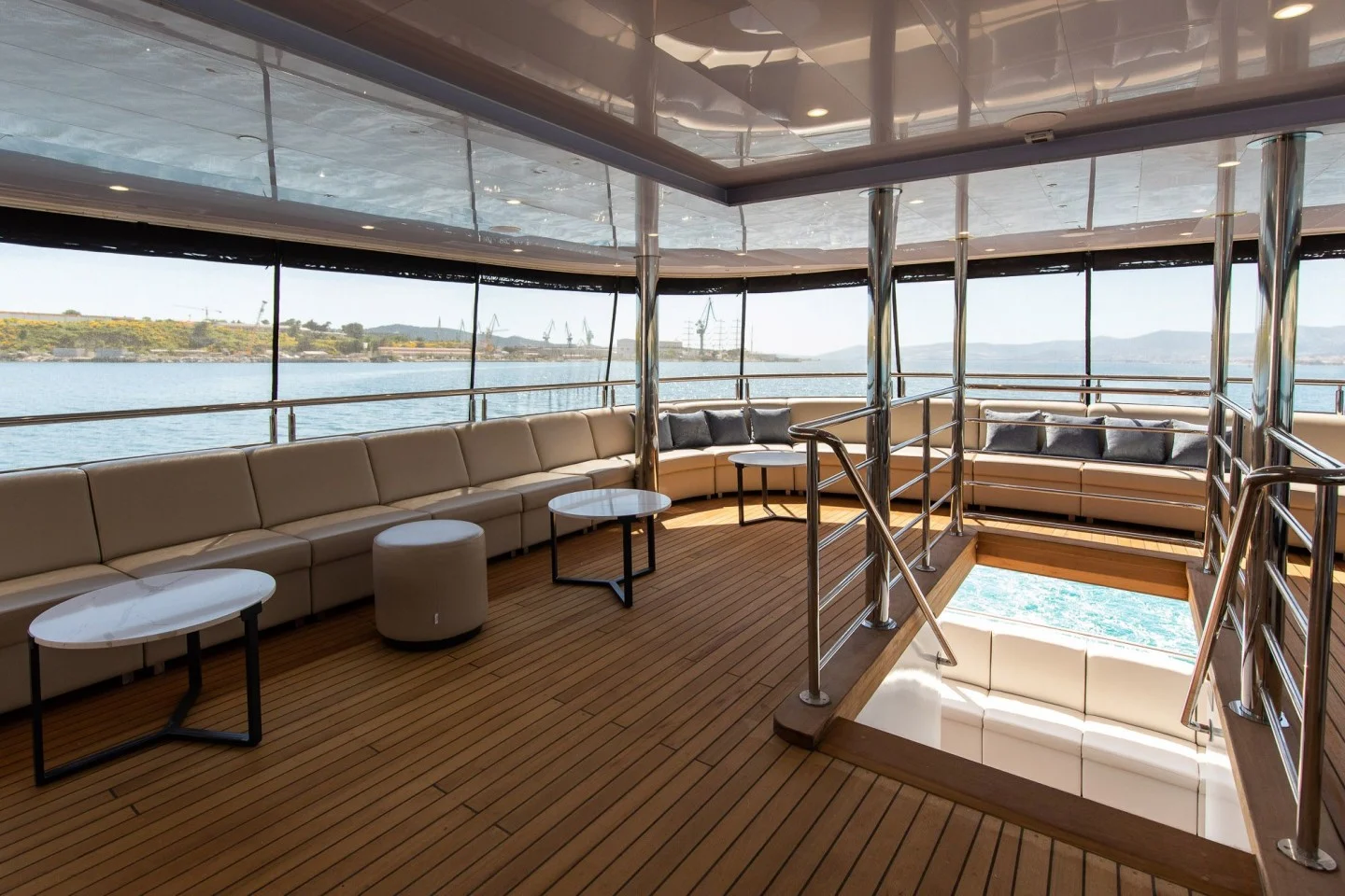 Covered aft lounge with wraparound seating and sea views